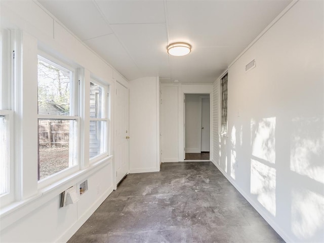 unfurnished room featuring plenty of natural light and ornamental molding