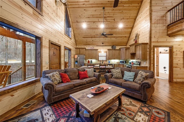 living room with wooden walls, hardwood / wood-style flooring, wood ceiling, and high vaulted ceiling