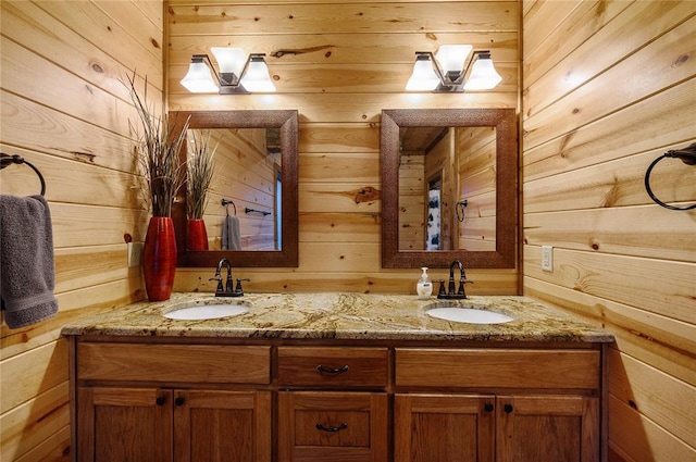 bathroom featuring wooden walls and vanity