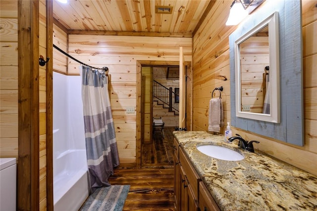 bathroom featuring shower / bath combination with curtain, wood walls, and wood-type flooring