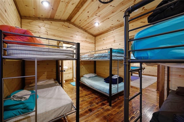 bedroom with hardwood / wood-style flooring, lofted ceiling, wood ceiling, and wooden walls