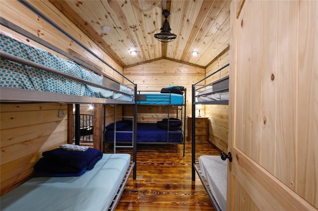 bedroom with wood ceiling, dark hardwood / wood-style floors, lofted ceiling, and wooden walls