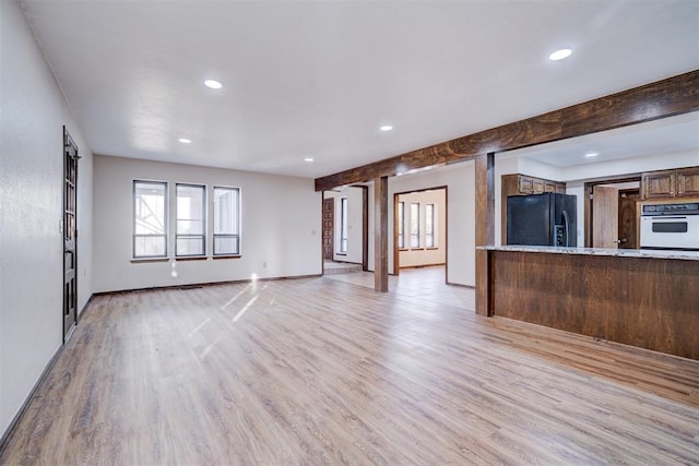 unfurnished living room with light wood-type flooring