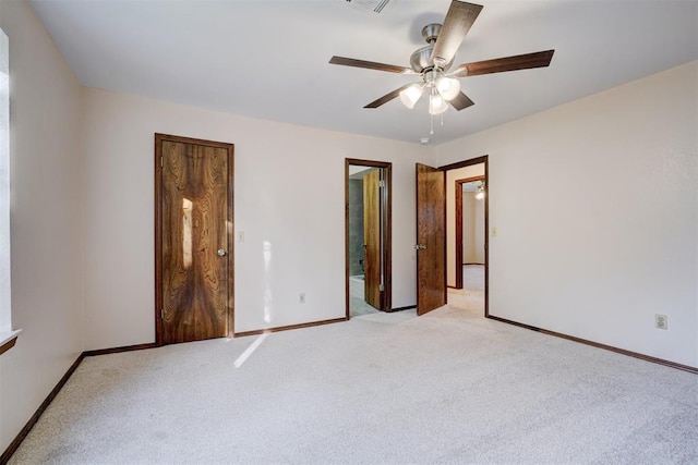 unfurnished bedroom with ensuite bath, ceiling fan, and light carpet