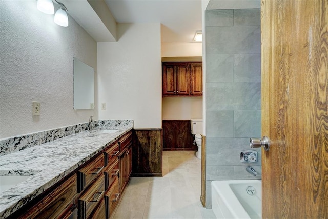 bathroom with tile patterned floors, vanity, and toilet