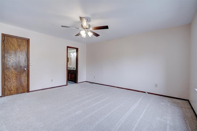 carpeted empty room featuring ceiling fan