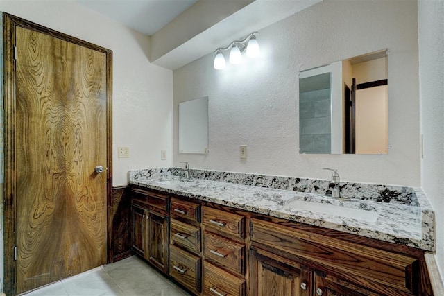 bathroom with tile patterned flooring and vanity