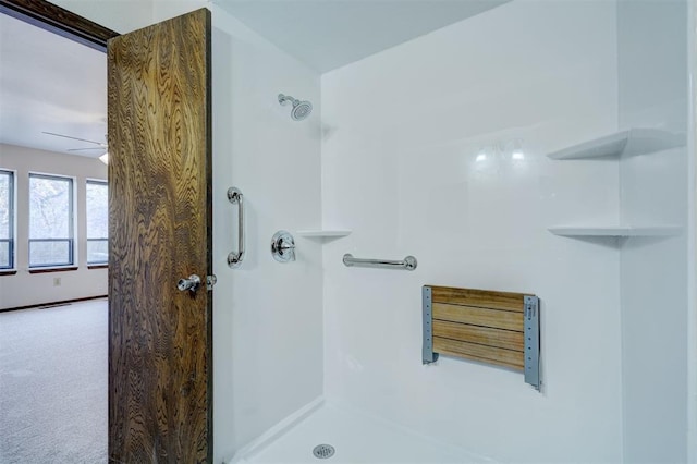 bathroom featuring ceiling fan and walk in shower