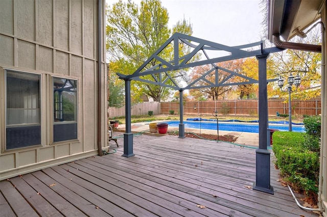 deck featuring a fenced in pool