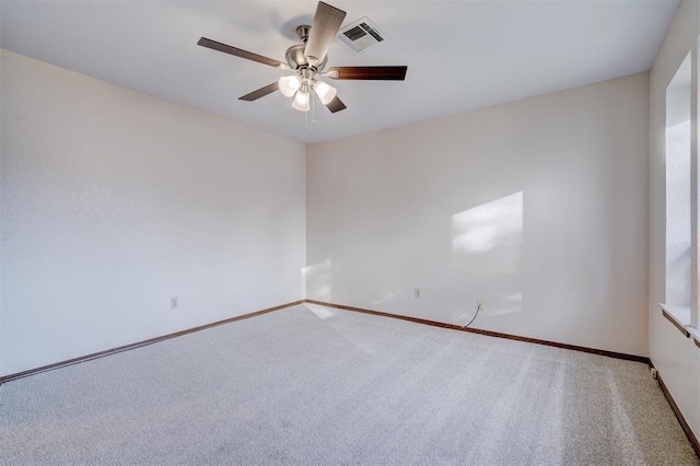 empty room with a ceiling fan, baseboards, visible vents, and carpet flooring