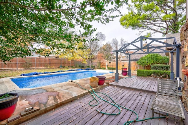 view of swimming pool featuring a fenced in pool, a fenced backyard, and a wooden deck