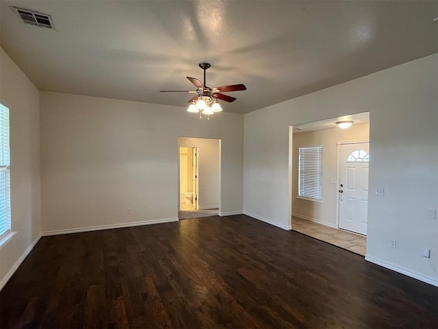 unfurnished room with dark hardwood / wood-style floors and ceiling fan