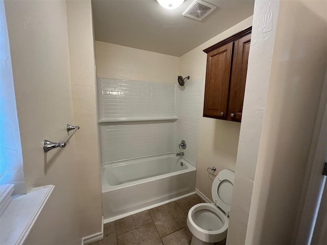 bathroom with tile patterned flooring, shower / bathing tub combination, and toilet