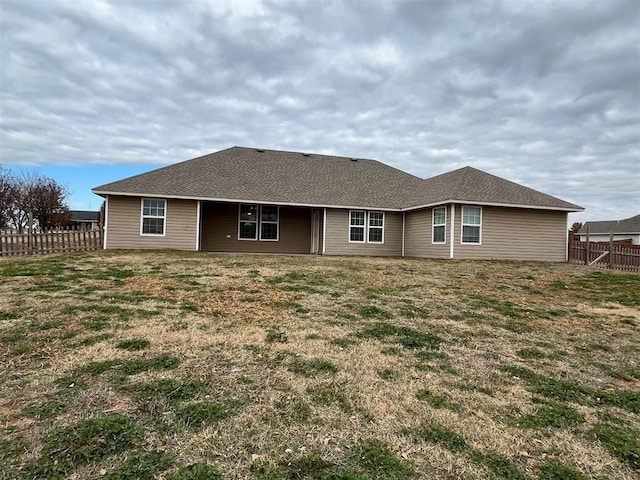 rear view of house with a yard