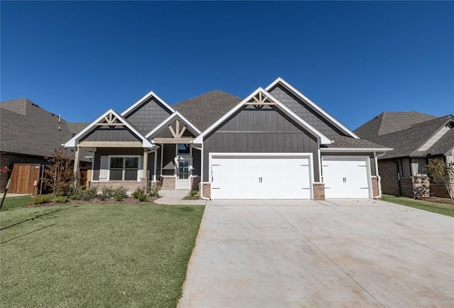 craftsman-style home featuring a garage and a front lawn