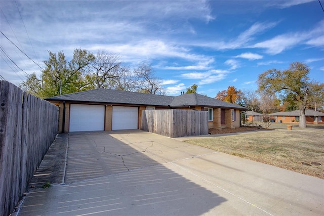 view of front of home with a front lawn and a garage