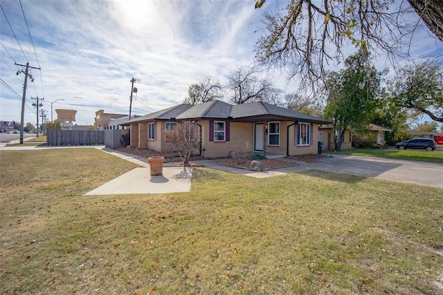 ranch-style house with a front yard and a patio