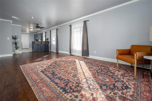 living room featuring ceiling fan, crown molding, and dark hardwood / wood-style floors