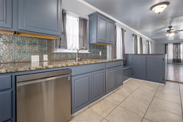 kitchen with sink, light tile patterned flooring, ornamental molding, stainless steel dishwasher, and dark stone counters