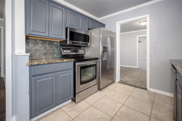 kitchen with tasteful backsplash, light tile patterned floors, crown molding, and appliances with stainless steel finishes