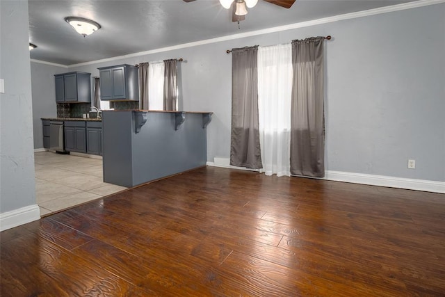 2100 Barclay Rd, Oklahoma City, OK 73120 - kitchen featuring a ceiling fan, gray cabinets, baseboards, stainless steel dishwasher, and ornamental molding
