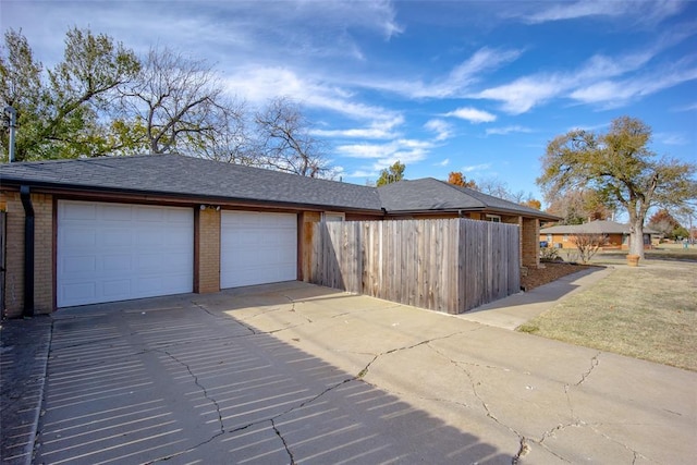 2100 Barclay Rd, Oklahoma City, OK 73120 - garage featuring driveway and fence