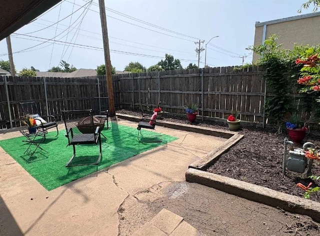 2100 Barclay Rd, Oklahoma City, OK 73120 - view of home's community featuring a fire pit, a fenced backyard, and a patio area