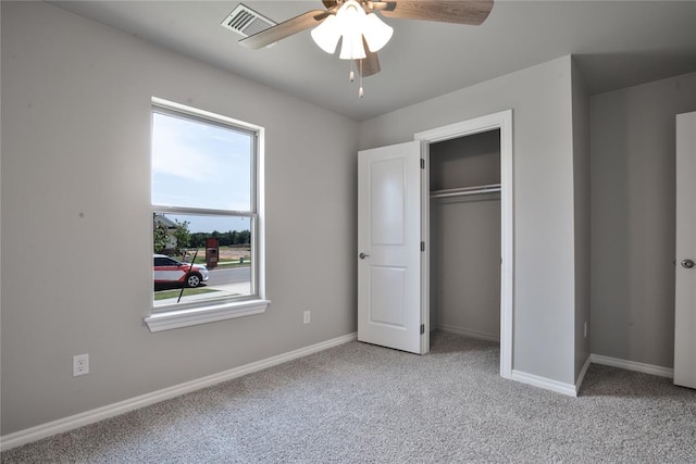 unfurnished bedroom with ceiling fan, a closet, and light colored carpet