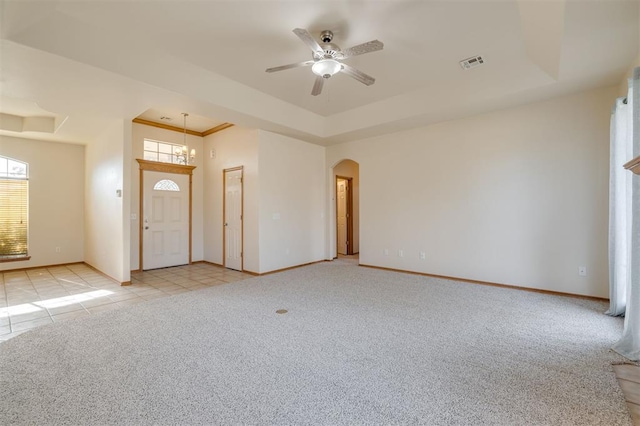 entryway featuring light colored carpet, ceiling fan, and a tray ceiling