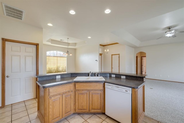 kitchen featuring dishwasher, a kitchen island with sink, light carpet, sink, and decorative light fixtures