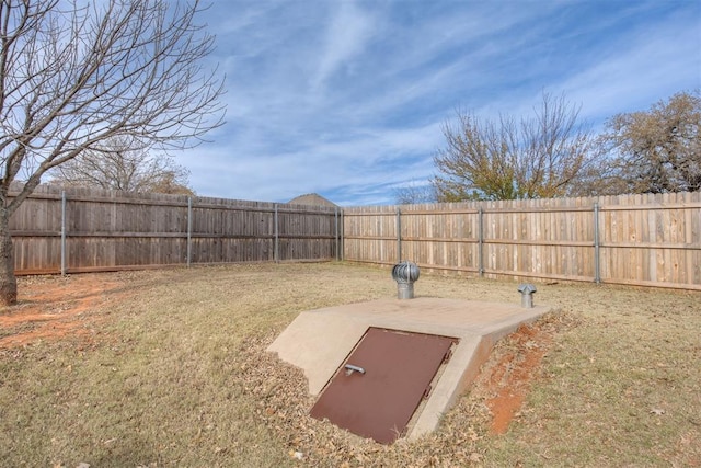 entry to storm shelter featuring a yard