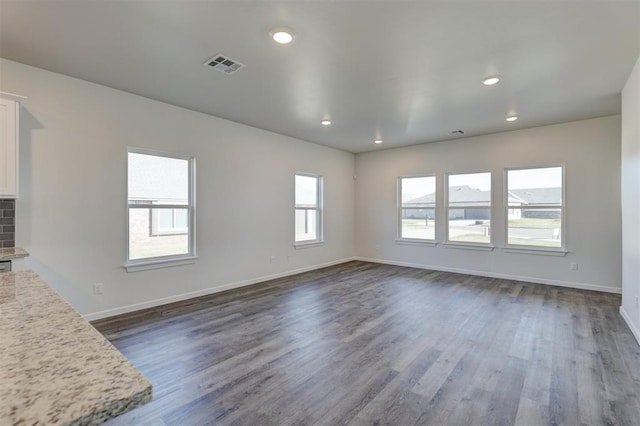 unfurnished living room featuring dark hardwood / wood-style floors