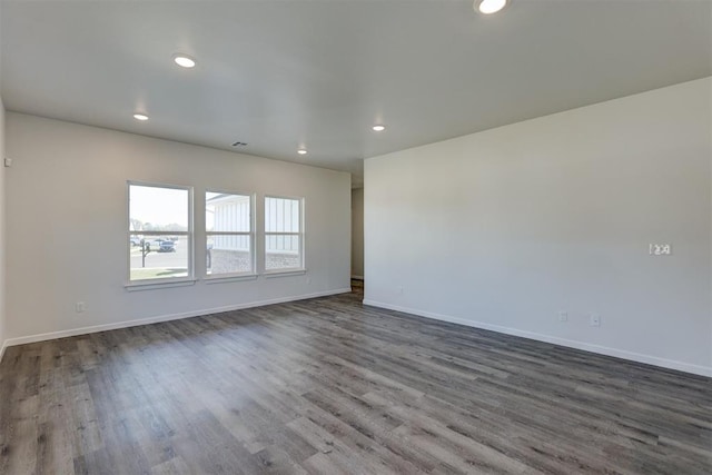 spare room with dark hardwood / wood-style floors