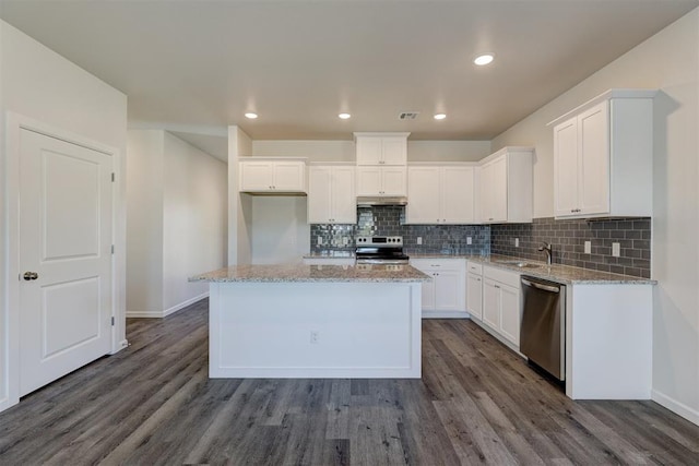 kitchen featuring appliances with stainless steel finishes, a center island, dark hardwood / wood-style floors, and white cabinetry