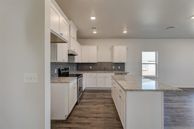 kitchen featuring light stone counters, white cabinets, a center island, dark hardwood / wood-style floors, and stainless steel electric range oven