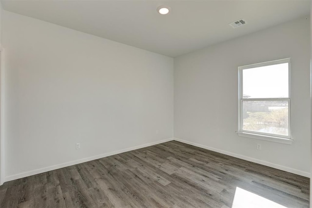 empty room with dark hardwood / wood-style flooring