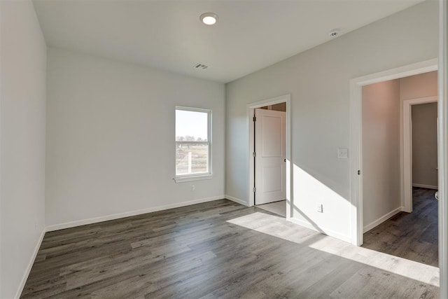 unfurnished bedroom featuring dark hardwood / wood-style floors