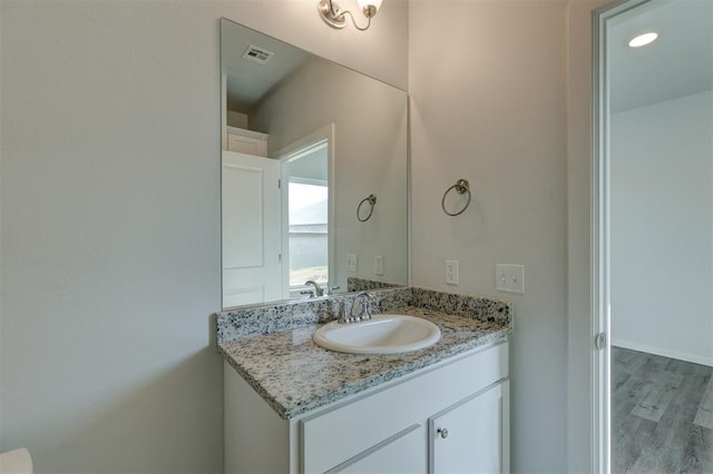 bathroom featuring hardwood / wood-style floors and vanity