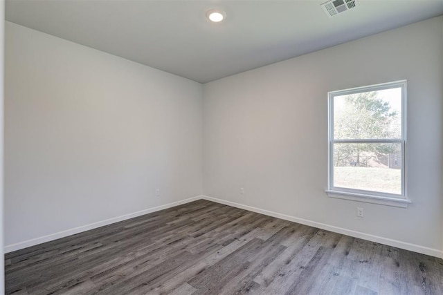 empty room with hardwood / wood-style floors