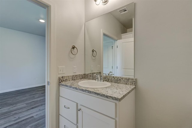 bathroom with hardwood / wood-style floors and vanity