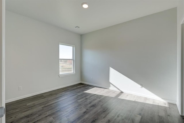 spare room with dark hardwood / wood-style floors