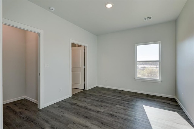 unfurnished bedroom featuring dark hardwood / wood-style flooring