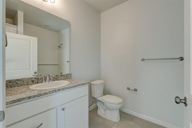 bathroom with tile patterned flooring, a shower, vanity, and toilet