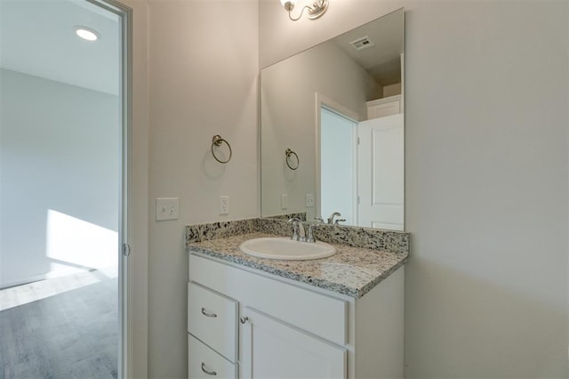 bathroom featuring vanity and hardwood / wood-style flooring