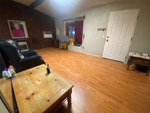 living room featuring wood-type flooring and brick wall