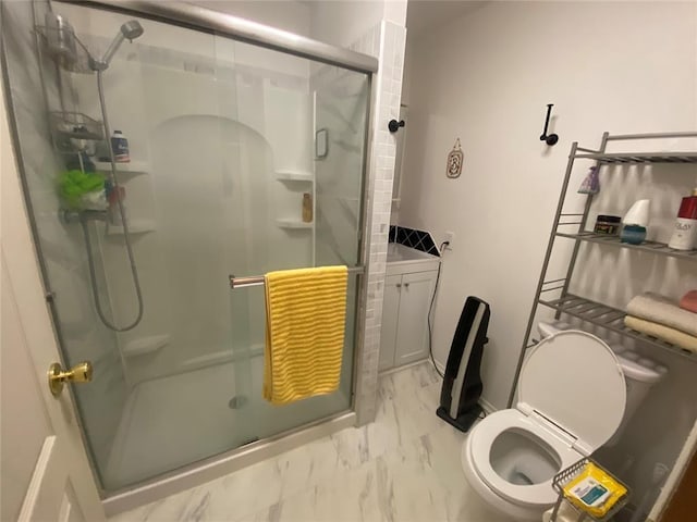 bathroom with toilet and a shower with door