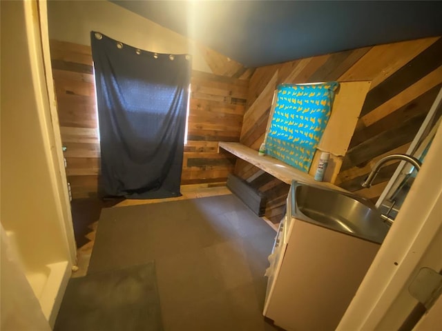 interior space with sink and wooden walls