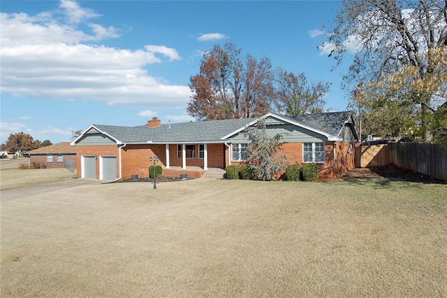 ranch-style house featuring a garage and a front yard