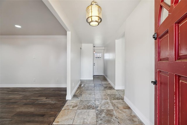 foyer entrance with hardwood / wood-style flooring and crown molding