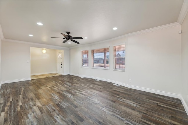 spare room featuring crown molding, ceiling fan, and dark wood-type flooring